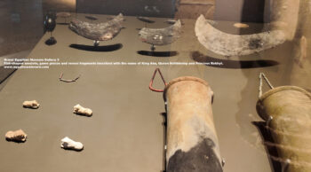 254-dynasty-1,-flint,-limestone,-ivory,-Naqada,-Ancient-Egypt,-History-Pharaohs,-Grand-Egyptian-Museum,-Fish-shaped-amulets,-game-pieces-and-vessel-fragments-inscribed