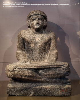 89-Dynasty-5,-granite,-Saqqara,-Ancient-Egypt,-History-Pharaohs,-Grand-Egyptian-Museum,-Unnamed-scribe-statue-reading-text-in-hieroglyphs-and-cursive-written-on-a-papyrus-roll